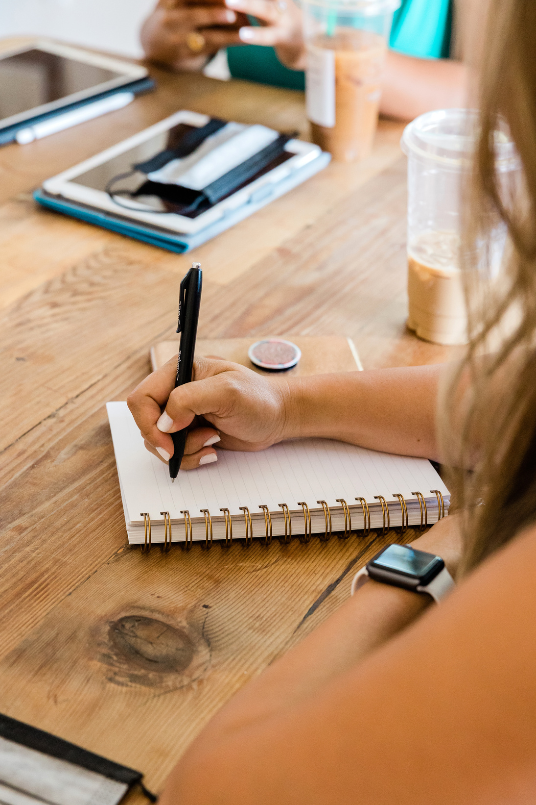 Woman Taking Notes in a Meeting